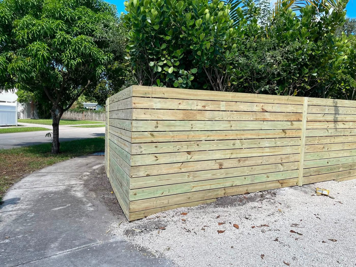Corner view of a completed horizontal wood privacy fence